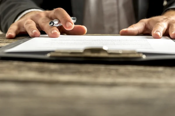 Closeup of male hand about to sign a subscription or application — Stockfoto