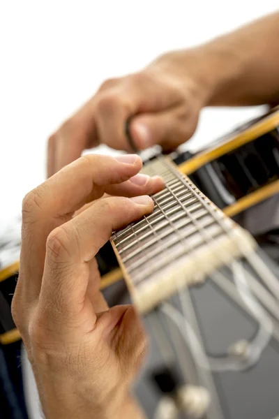 Closeup of male guitarist playing black jazz electric guitar — ストック写真