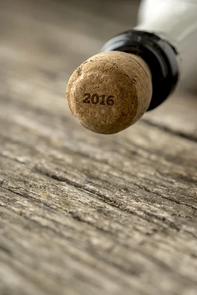 Верх бутылки шампанского с табличкой 2016 года на пробке — стоковое фото