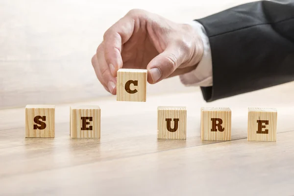 Security company employee assembling the word SECURE — Zdjęcie stockowe