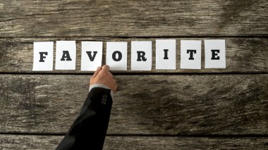 Male hand assembling the word Favorite