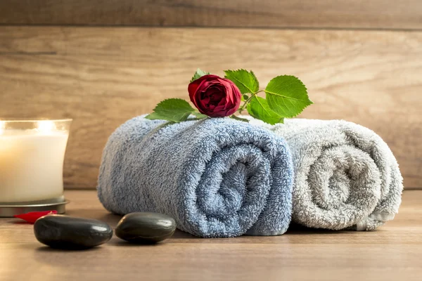 Romantic arrangement of two rolled towels with a beautiful red r — Stock Photo, Image