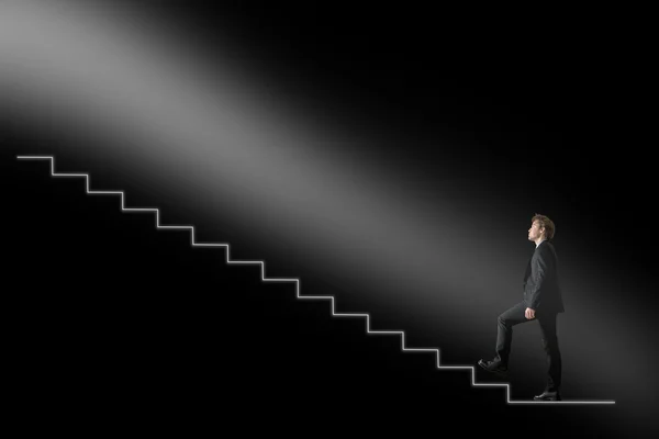 Businessman walking upwards towards the light on conceptual stai — Stock Photo, Image