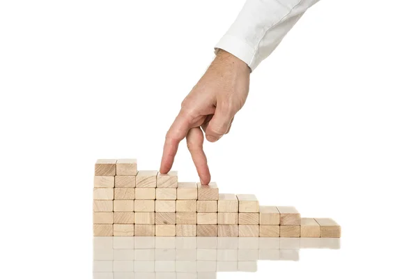 Male hand walking his fingers up wooden staircase made of pegs — Stock Photo, Image