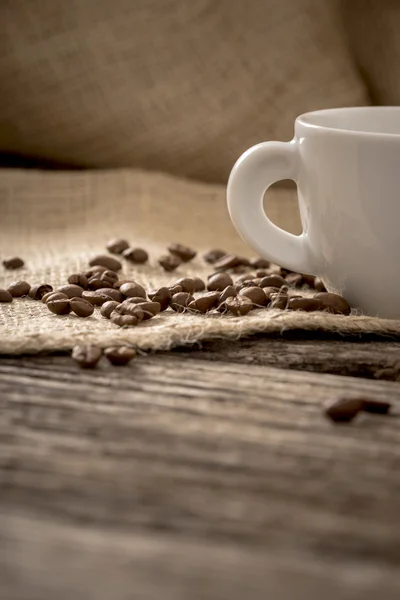 Низкий угол зрения кофейных зерен, разбросанных по льняной ткани лежащих на — стоковое фото