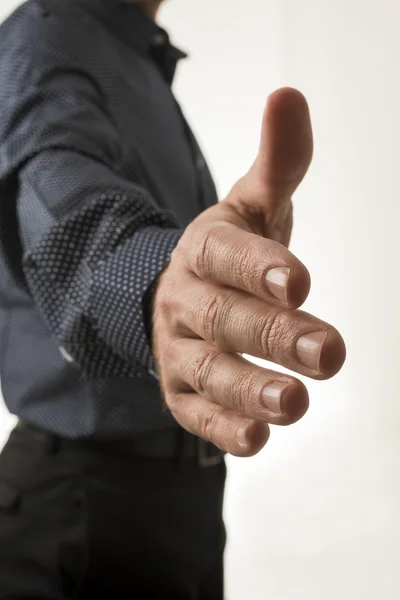 Closeup view of a man in elegant business suit offering his hand — Stock Photo, Image