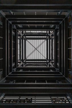 Upward view inside metal tower construction  clipart