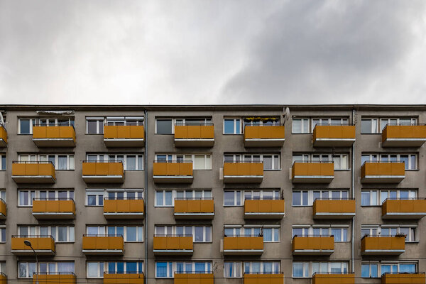 Facade of big block of flats with orange balconies