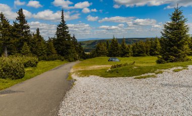Long mountain trail with panorama if Karkonosze Giant Mountains around clipart