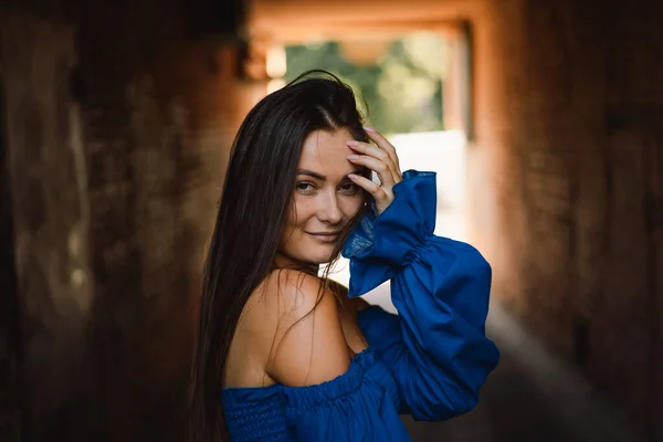 Portrait happy young woman wearing blue dress laughing looking at camera standing on street. Urban background — Stock Photo, Image