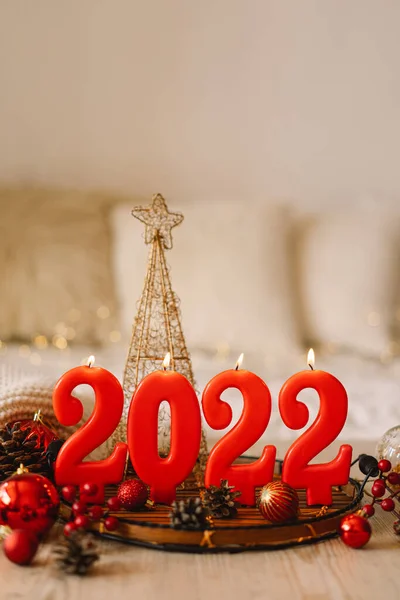 สุขสันต์วันปีใหม่ 2022. ตัวเลขของปี 2022 ทําโดยเทียนสีแดงบนพื้นหลังที่ส่องแสงเทศกาล bokeh — ภาพถ่ายสต็อก