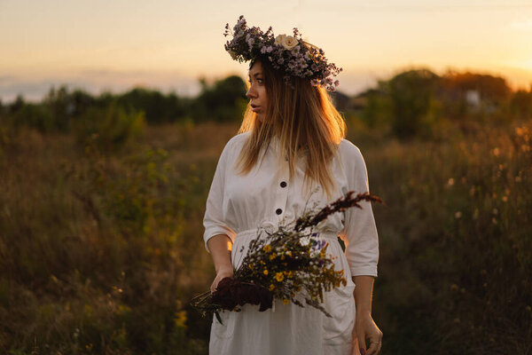 Portrait of a pregnant woman. A beautiful young pregnant woman in a white dress walks in the field. Happy pregnancy. Concepts of pregnancy. Romantic mood. Nature lover.