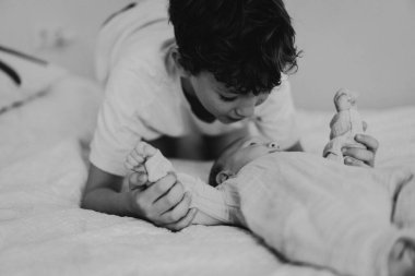 Two little boys brothers enjoying playing in cozy bright bedroom, smiling and playing. Happy childhood. Children portraits.