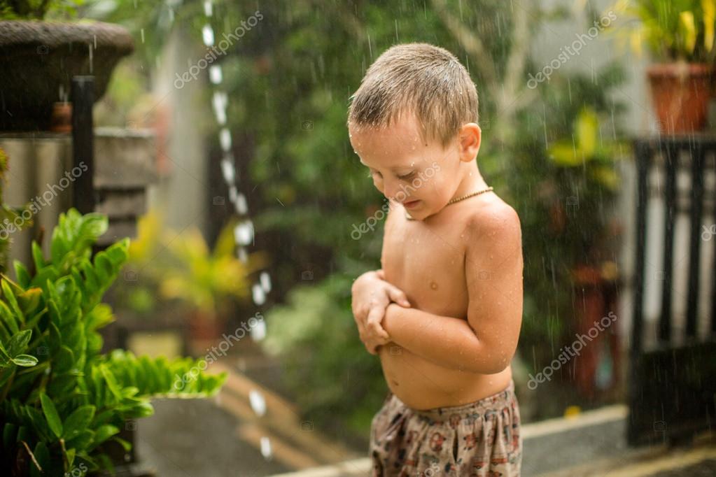 Cute baby boy playing under the rain Stock Photo by ©Haribol_108 101083474