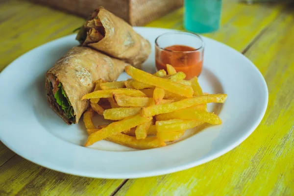 Vegetarian lunch. Vegetable rolls and fries