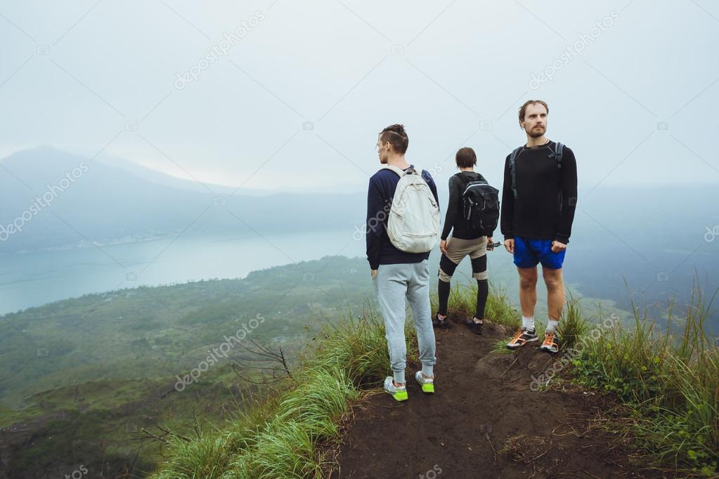 3 Hikers man looking at sunrise on the mountain,freedom concept.