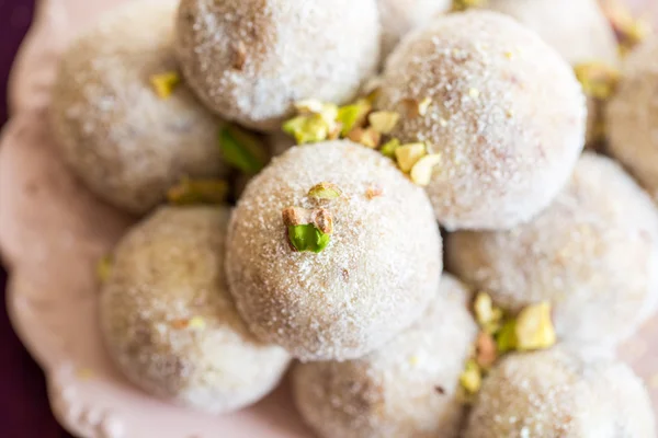 Homemade coconut balls decorated with little pink flowers — Stock Photo, Image