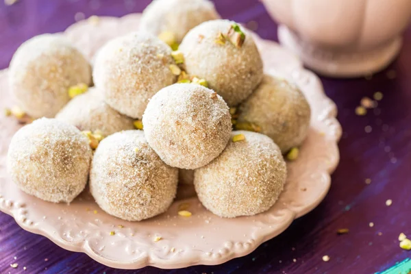 Homemade coconut balls decorated with little pink flowers — Stock Photo, Image