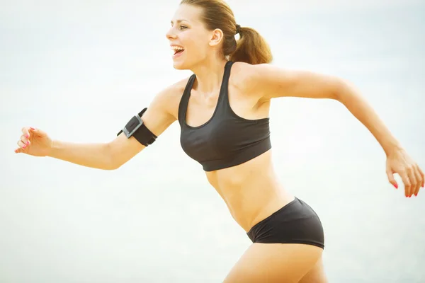 Beautiful woman running on the beach — Stock Photo, Image