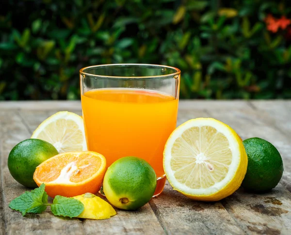 Χυμό πορτοκαλιού με λεμόνι, ασβέστης και μέντα σε έναν ξύλινο πίνακα — Φωτογραφία Αρχείου