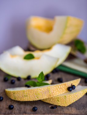 taze kavun ve yaban mersini bir ahşap kesme tahtası üzerinde. Seçici