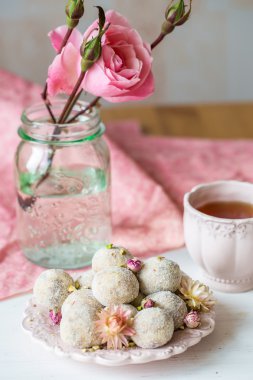 Homemade coconut balls decorated with little pink flowers clipart