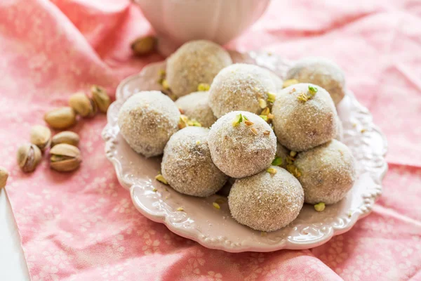 Homemade coconut balls decorated with little pink flowers — Stock Photo, Image