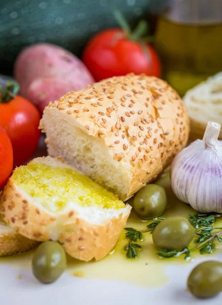 Azeite virgem extra sobre baguete branca e legumes — Fotografia de Stock