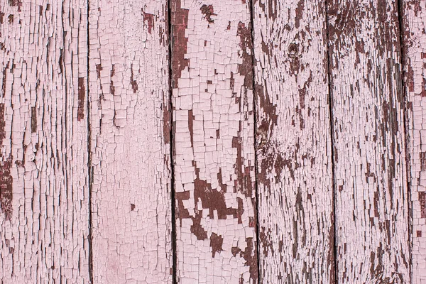 Viejos tablones de madera pintados con pintura rosa agrietada por una ba rústica — Foto de Stock