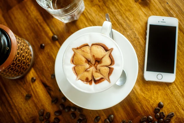 High angle view of smart phone with blank screen and Cappuccino — Stok fotoğraf