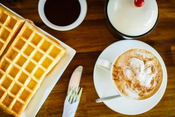 Waffles with chocolate and coffee on the wooden table — Stockfoto