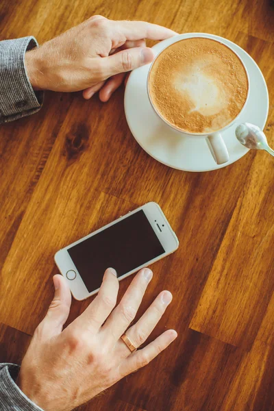 Men's hands hold the tablet with coffee — Stock Photo, Image