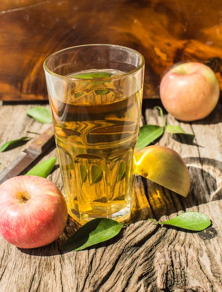 Apple juice on a wooden board — Stock Photo, Image