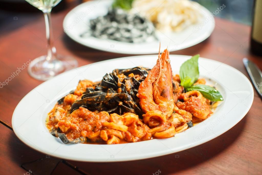 Traditional Italian dish - black tagliatelle with seafood