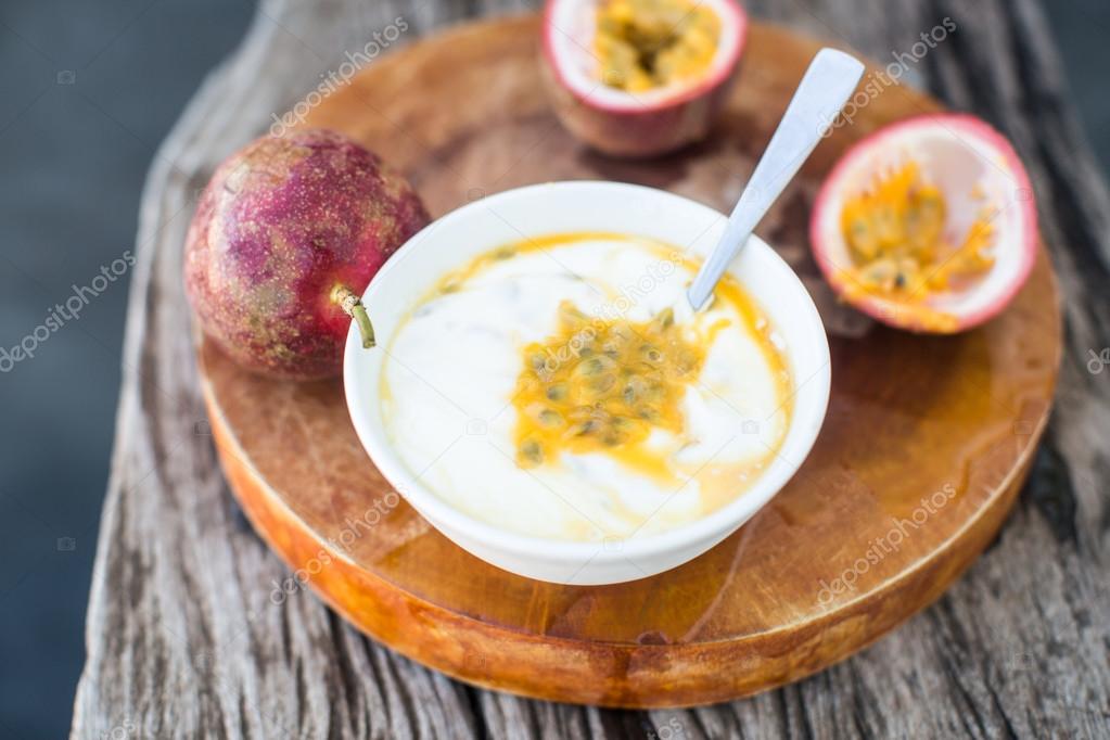 Yogurt with passion fruit in a white bowl