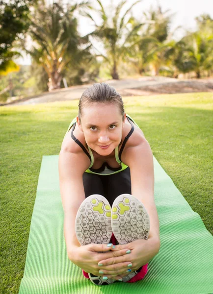 Sabah parkında yoga yapan genç bir kadın. — Stok fotoğraf