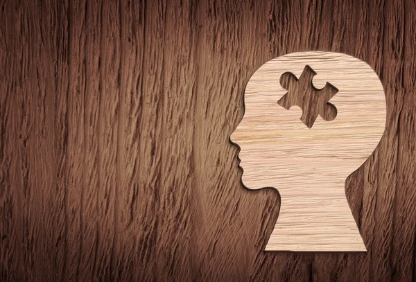 Human head silhouette with a jigsaw piece cut out — Stock Photo, Image
