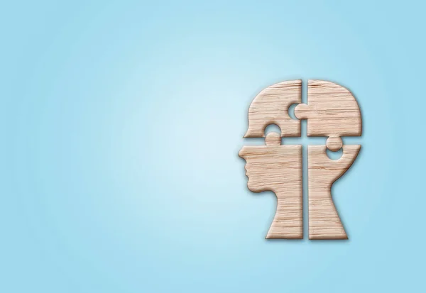 人間の頭のシルエット 青い背景にカットされたジグソーピース 精神的な健康のシンボル — ストック写真