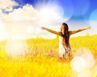 Happy girl enjoying the happiness on sunny meadow