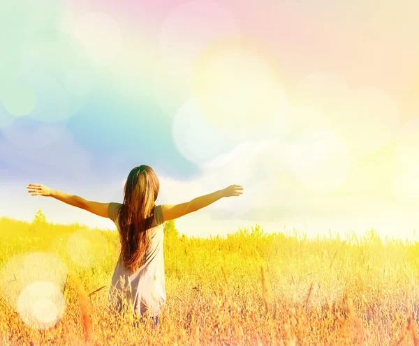 Happy girl enjoying the happiness on sunny meadow