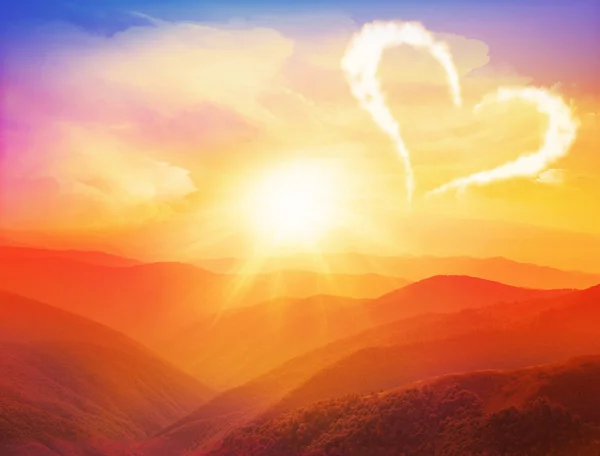 Sunset in the mountains landscape with heart. Valentines day