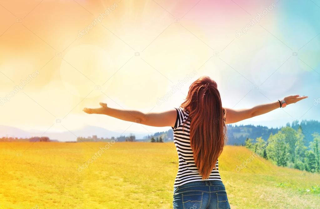 Young girl spreading hands with joy and inspiration 