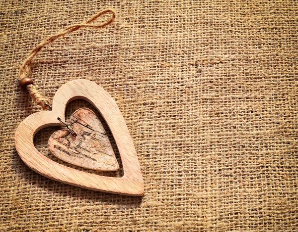 Two wooden hearts on sackcloth, canvas background. Vintage style. — Stock Photo, Image