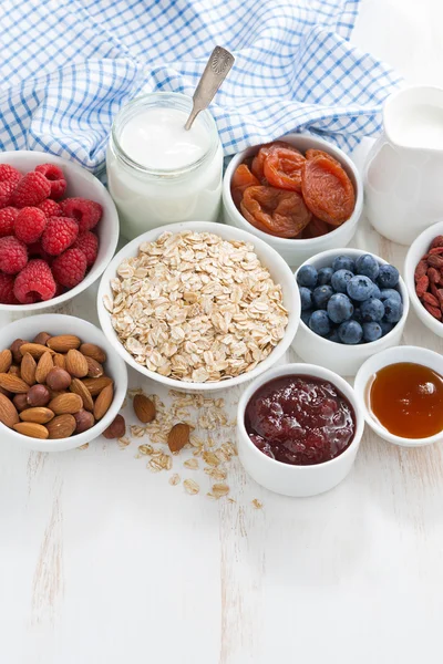 Copos de avena y varios ingredientes deliciosos para el desayuno — Foto de Stock