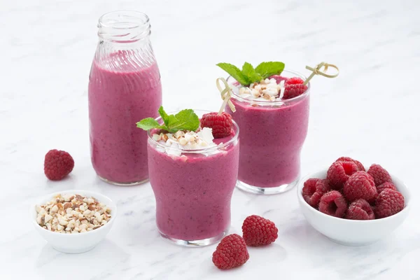 Fresh berry smoothies with nuts on white table — Stock Photo, Image