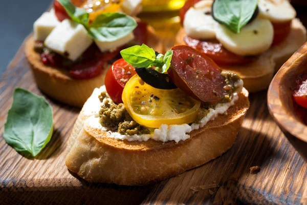 Italian appetizers - various bruschettas, closeup — Stock Photo, Image