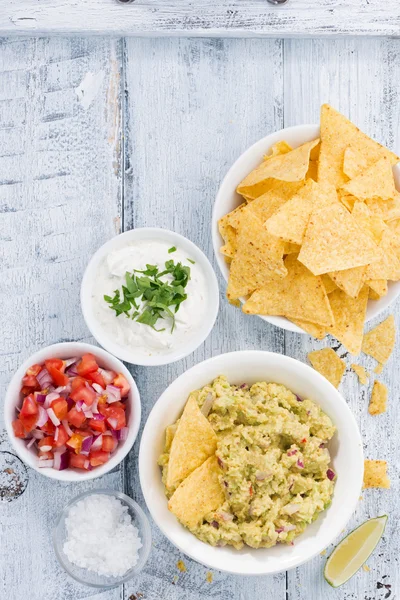 Spicy avocado sauce and assorted sauces with corn chips — Stock Photo, Image