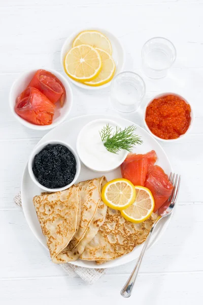 Traditionella ryska crepes med kaviar och saltad fisk, ovanifrån — Stockfoto