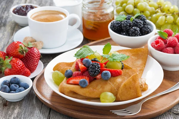Breakfast - crepes with fresh berries and honey, coffee — Stock Photo, Image