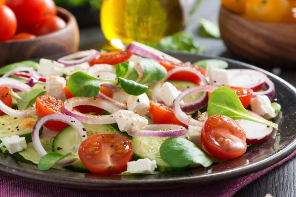 Fresh vegetable salad with feta cheese on a plate — Stock Photo, Image